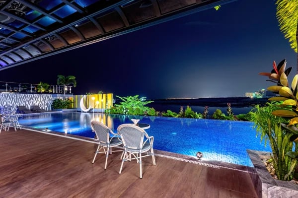 a pool with chairs and tables and chairs