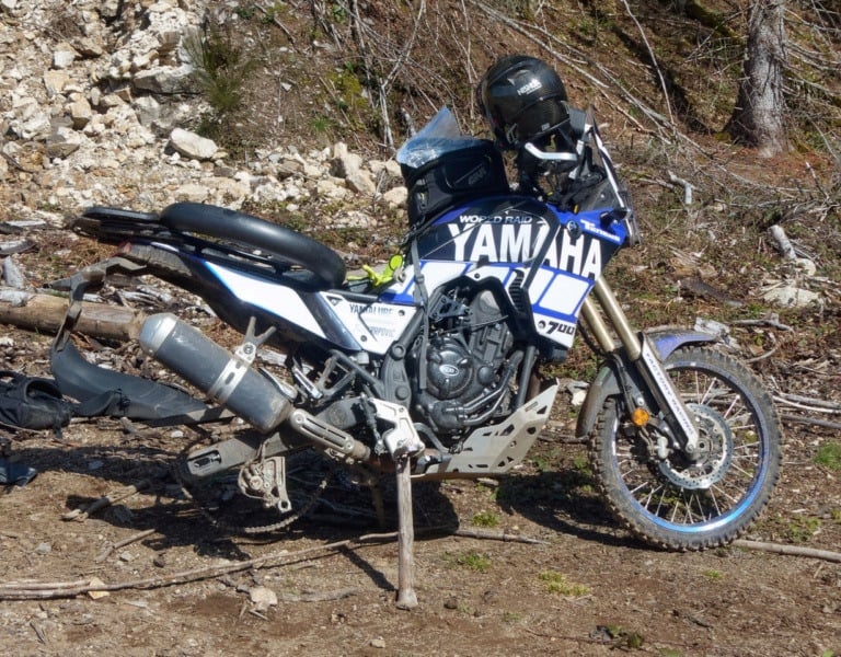 a motorcycle parked on a dirt road