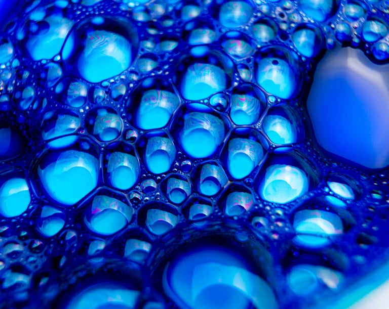 a blue bowl of DarkBlue liquid with bubbles of water in it