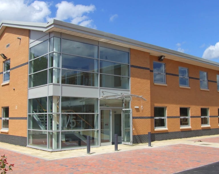commercial building with beautiful glass entrance atrium, customer of C Thru Window Cleaning, Exeter.