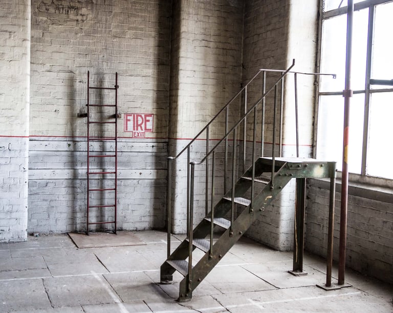 Original fire exit and metal loading stairs along with the Stone floor and 6 metre high original windows at Atlas Studios