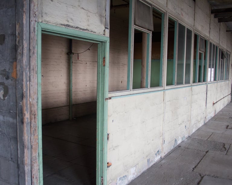 Original Overseers office in the Stone room, with peeling paint and industrial feel in the Stone room at Atlas Studios.