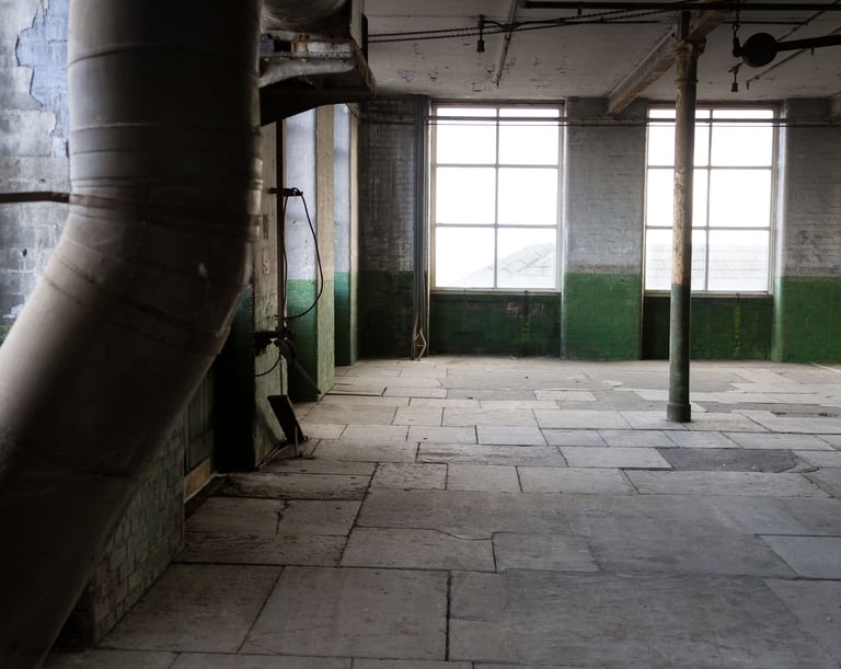 Original industrial pipework and gears in the Stone Room at Atlas Studios