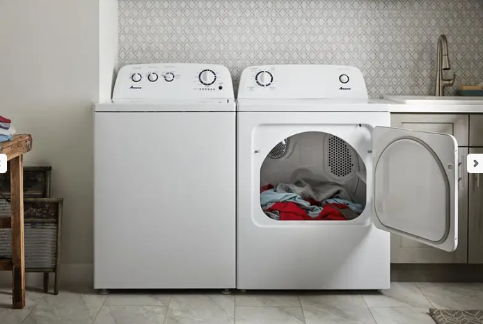 White color washer dryer, dryer's door is open and there are some clothes inside