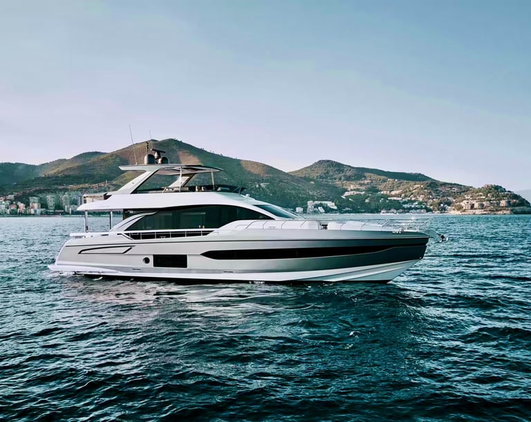 Luxury yacht cruising on open waters with scenic coastal backdrop.