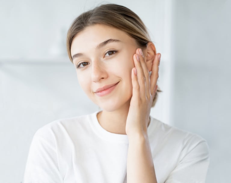 woman with clear skin touching own face