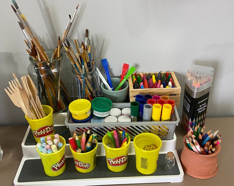 Display of art materials including crayons and paintbrushes