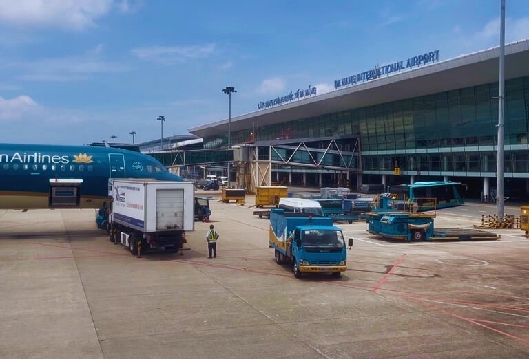 Passenger aircraft at Da Nang airport being serviced by ground crew