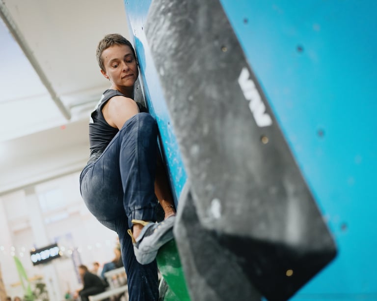 a woman bouldering on a climbing wall