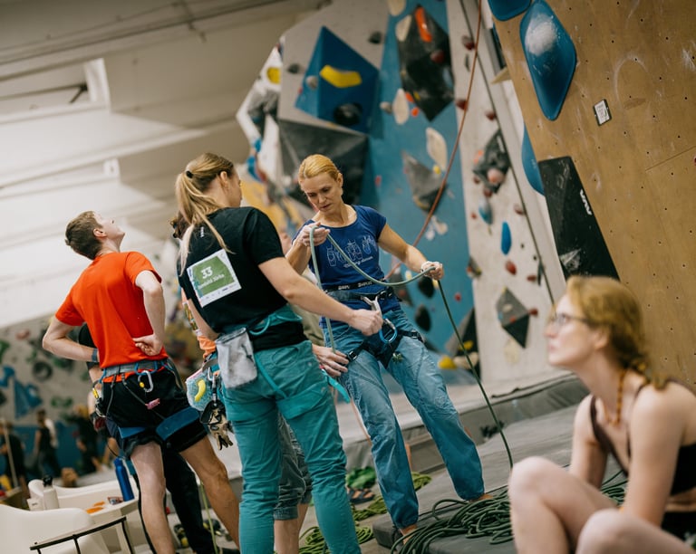 climbers in a climbing wall are checking the rope