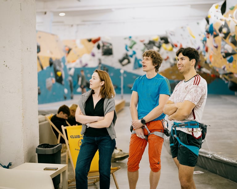 a group of people standing in climbing wall