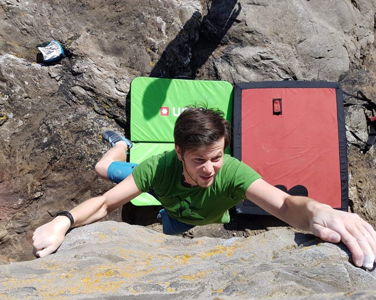 a man bouldering on a rock