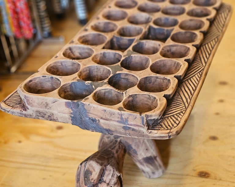 a giant wooden board game with with holes old ancient game with a shape of a turtle