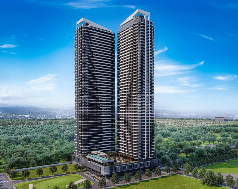Modern twin luxury skyscraper residential towers overlooking a lush green city park under a blue sky.