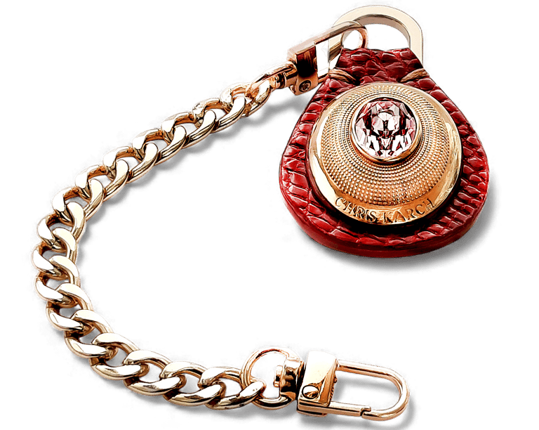 Luxury gold link chain keychain with a red leather pendant and pink crystal embellishment.