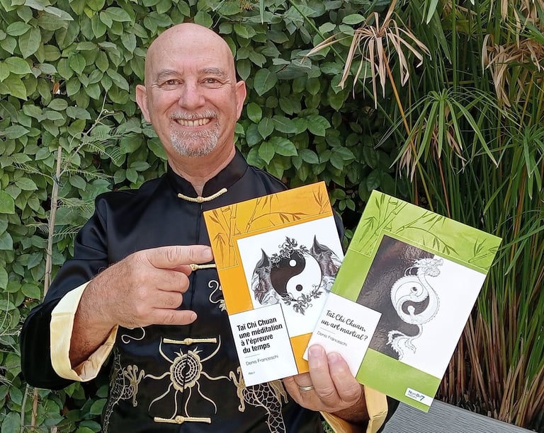 a man in a black shirt holding up a book