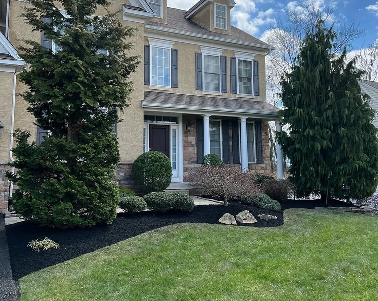 excellent landscaping and hardscaping of grass, stones and trees by NP Landscaping