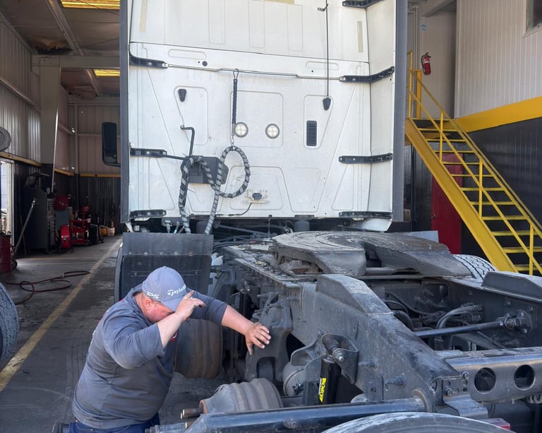 a man working on a truck in a garage
