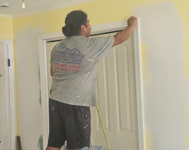 a man is painting a wall in a room