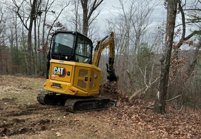 CAT excavator digging up dirt