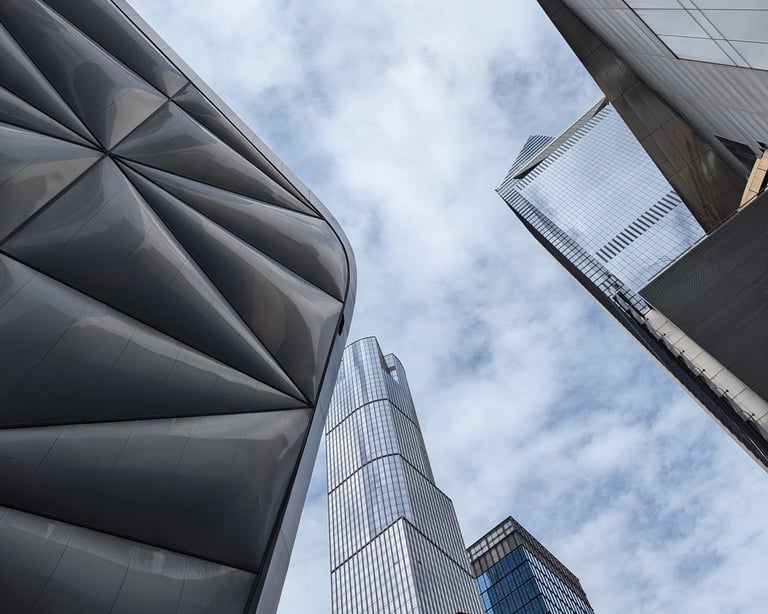 A view looking up into the sky from a place between several office buildings