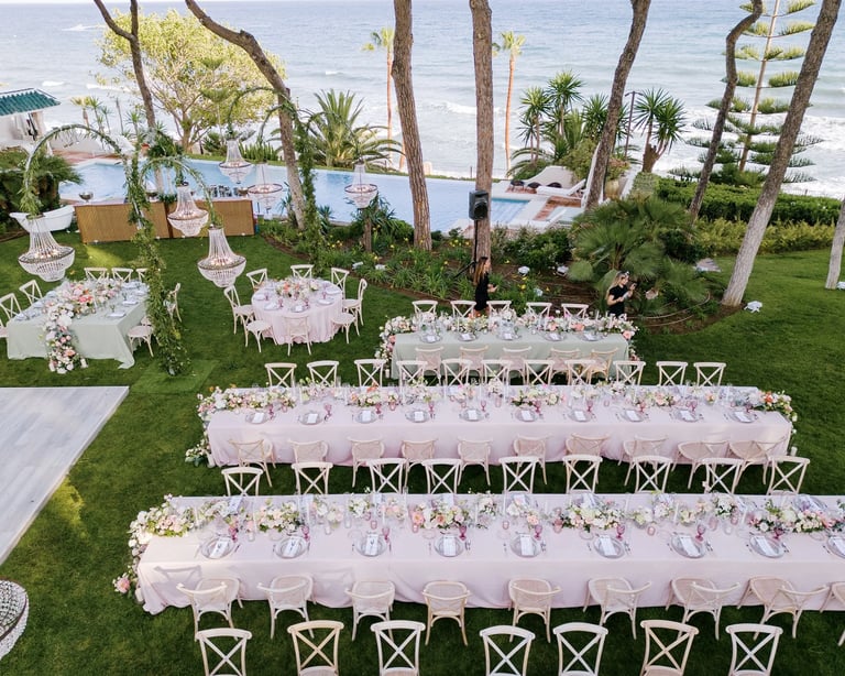 Seafront wedding dinner setup beside infinity pool