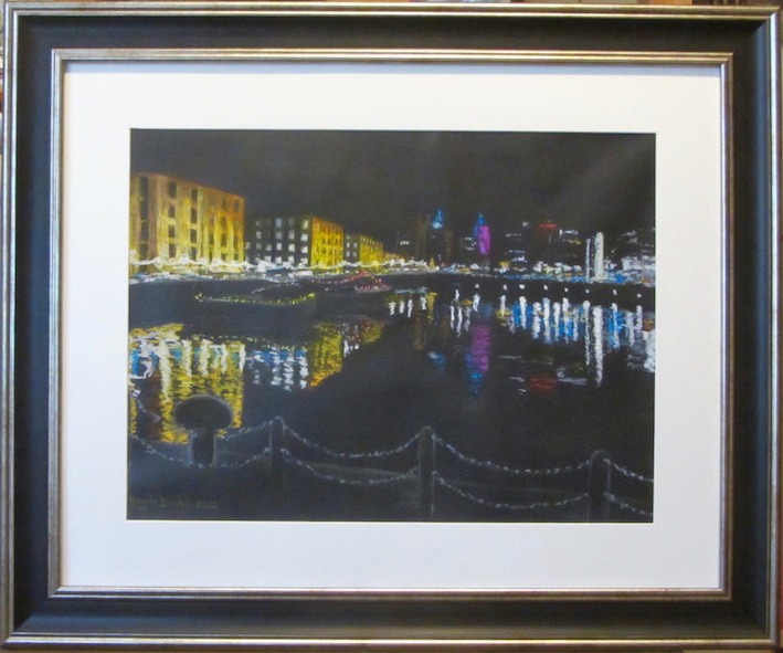 Reflections of lit-up buildings sparkle on the water of Albert Dock in Liverpool. Drawn in soft pastel on black paper. 