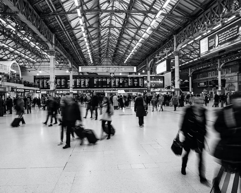 a group of people walking through a train station