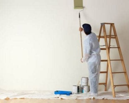 un pintor pinta una pared blanca
