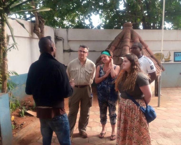 Dahomey African Tours Guide leading tourists in Pythons Temple in Benin