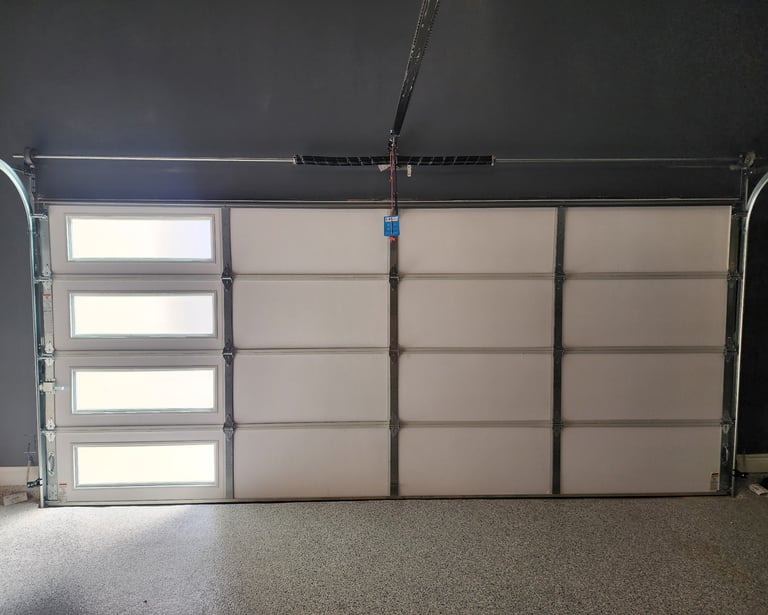 Installed insulation on garage door for temperature control by On Point Overhead doors
