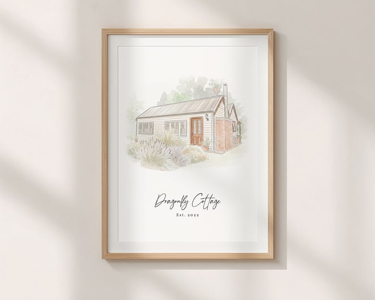 A minimalist ink and watercolor painting of a cottage hangs on a wall