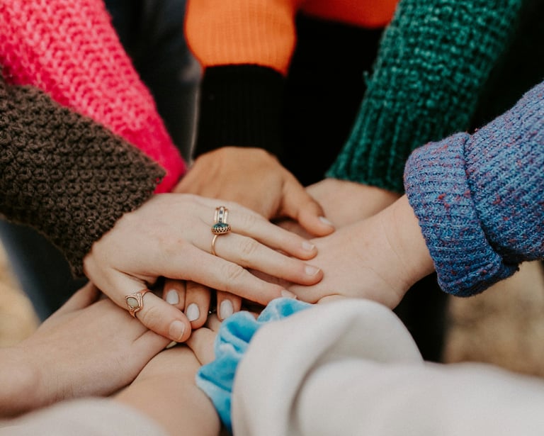 a group of people holding hands together