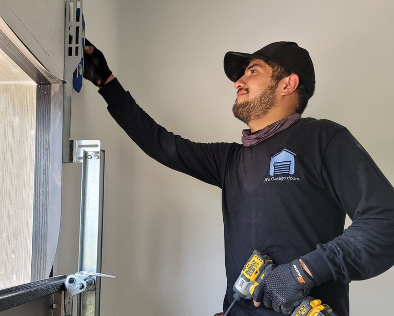 Alex with On Point Overhead Doors repairing a garge door in Kyle TX