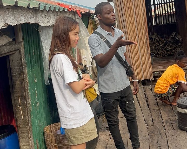 Dahomey African Tours Guide leading Tourists in Ganvie Stilt Village in Benin