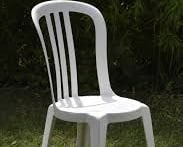 a white plastic chair with a white chair and a black chair