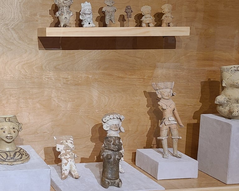 Miniture scultpures depicting Hausteca in display case