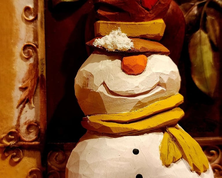 hand carved snowman with tophate and scarf, carved in basswood by James Smith