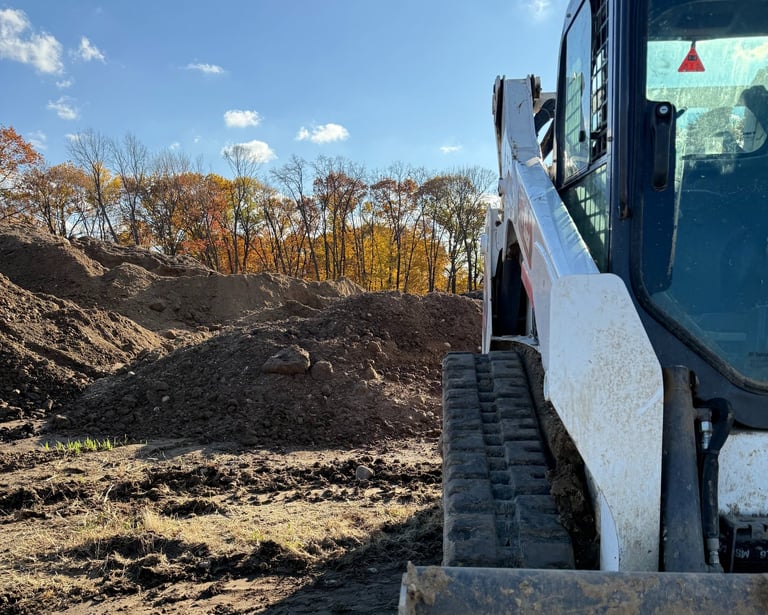 skid-steer-with-dirt-pile