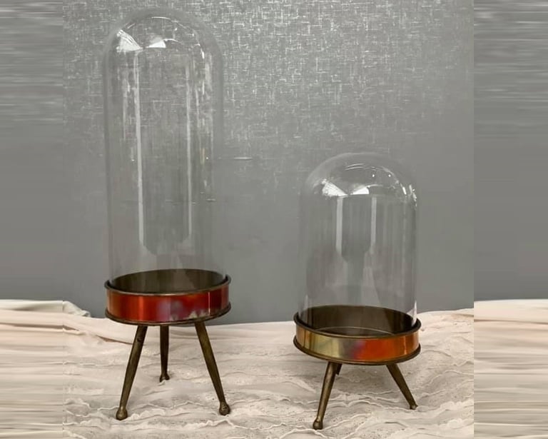 two glass bell bellow with a glass dome