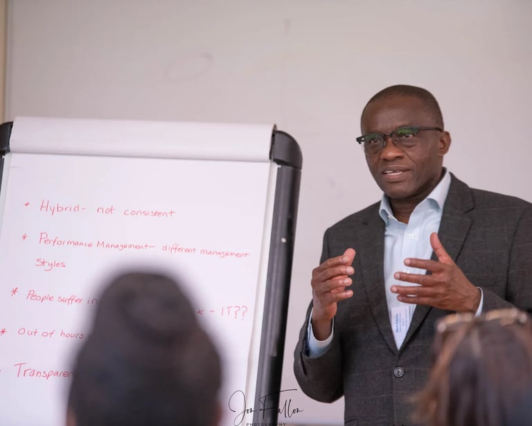 Business professional leading a corporate workshop on performance management and hybrid work styles.