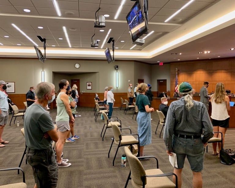 Photo of people standing in support of an item at city council