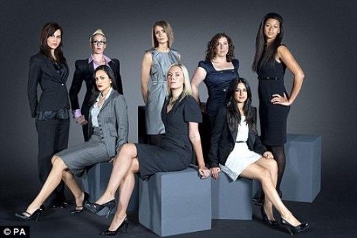 a group of women in business attire posing for a picture