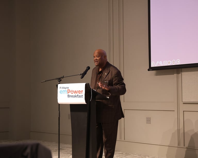 A man speaking at a podium during the Fort Wayne emPower Breakfast event.