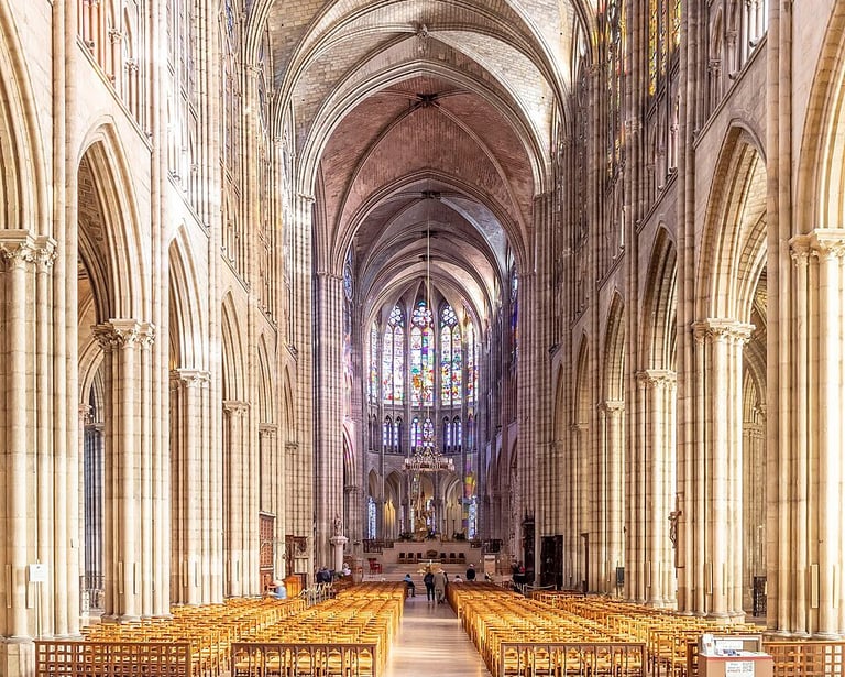 Gothic interior nave and stained glass windows of the Basilica of Saint-Denis, on a guided tour