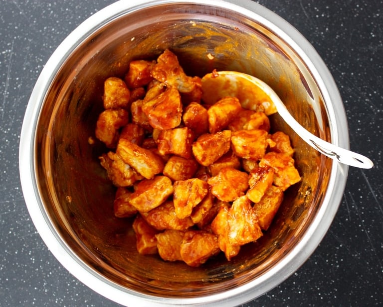 chunks of chicken fried and tossed in buffalo sauce