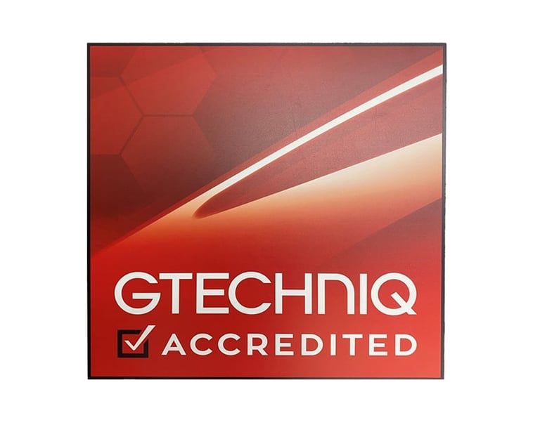 Gtechniq Accredited logo on a red background with a checkmark for certified car detailing services.
