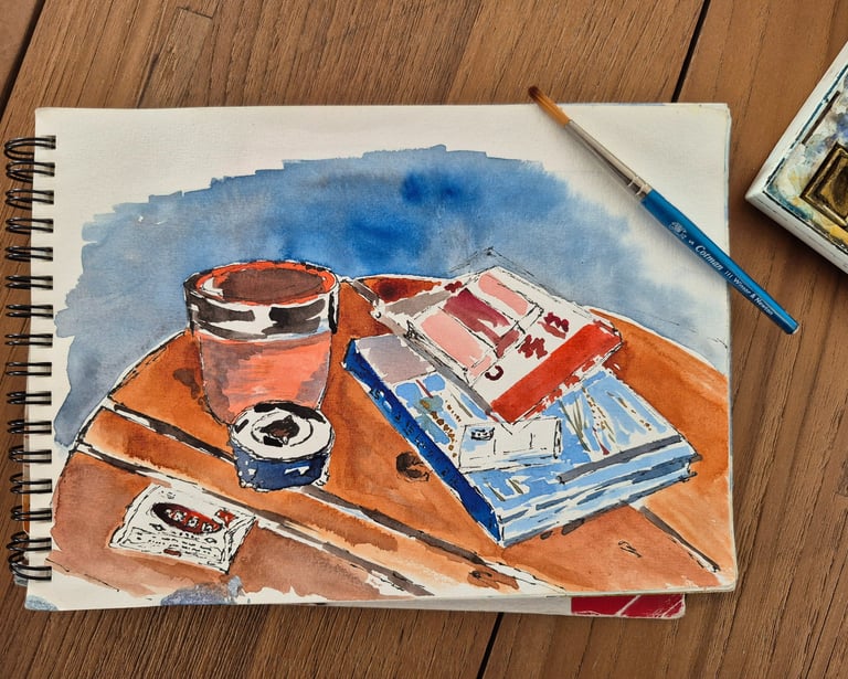 watercolor drawing of a cup of coffee and paing matterials