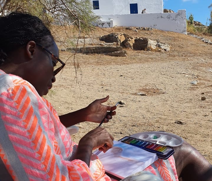 a group participant painting by the beach