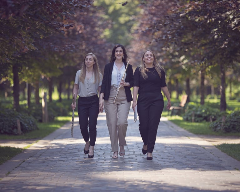 three women walking down a path in a park
